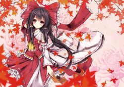  absurdres autumn_leaves black_hair blush detached_sleeves hair_ornament hakurei_reimu haruno_nanakusa highres long_hair looking_at_viewer red_eyes ribbon smile solo talisman touhou 