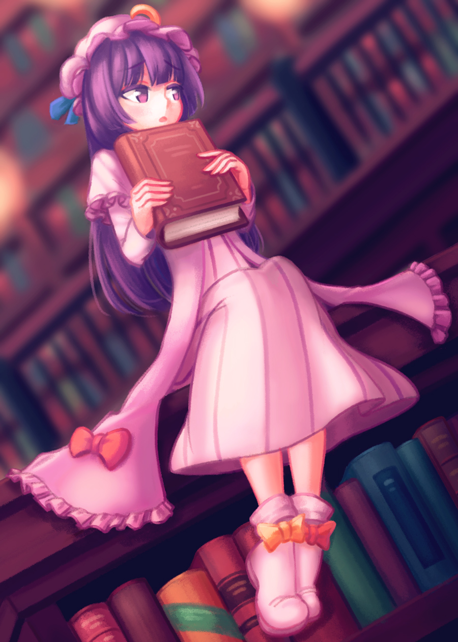 1girl bangs blue_ribbon blunt_bangs book bookshelf capelet crescent double_bun dress frilled_dress frills highres holding holding_book library long_hair looking_to_the_side makaroll mob_cap open_mouth pajamas patchouli_knowledge purple_hair red_ribbon ribbon sitting solo touhou violet_eyes voile