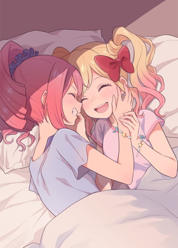 2girls aikatsu! aikatsu_stars! bed bed_sheet blonde_hair blue_shirt blush bow bracelet closed_eyes frills gobou_1000 gradient_hair grin hair_bow hand_on_another's_cheek hand_on_another's_face happy jewelry multicolored_hair multiple_girls nijino_yume on_bed open_mouth pillow pink_hair pink_shirt red_bow redhead sakuraba_rola shirt short_sleeves sidelocks smile twintails yuri