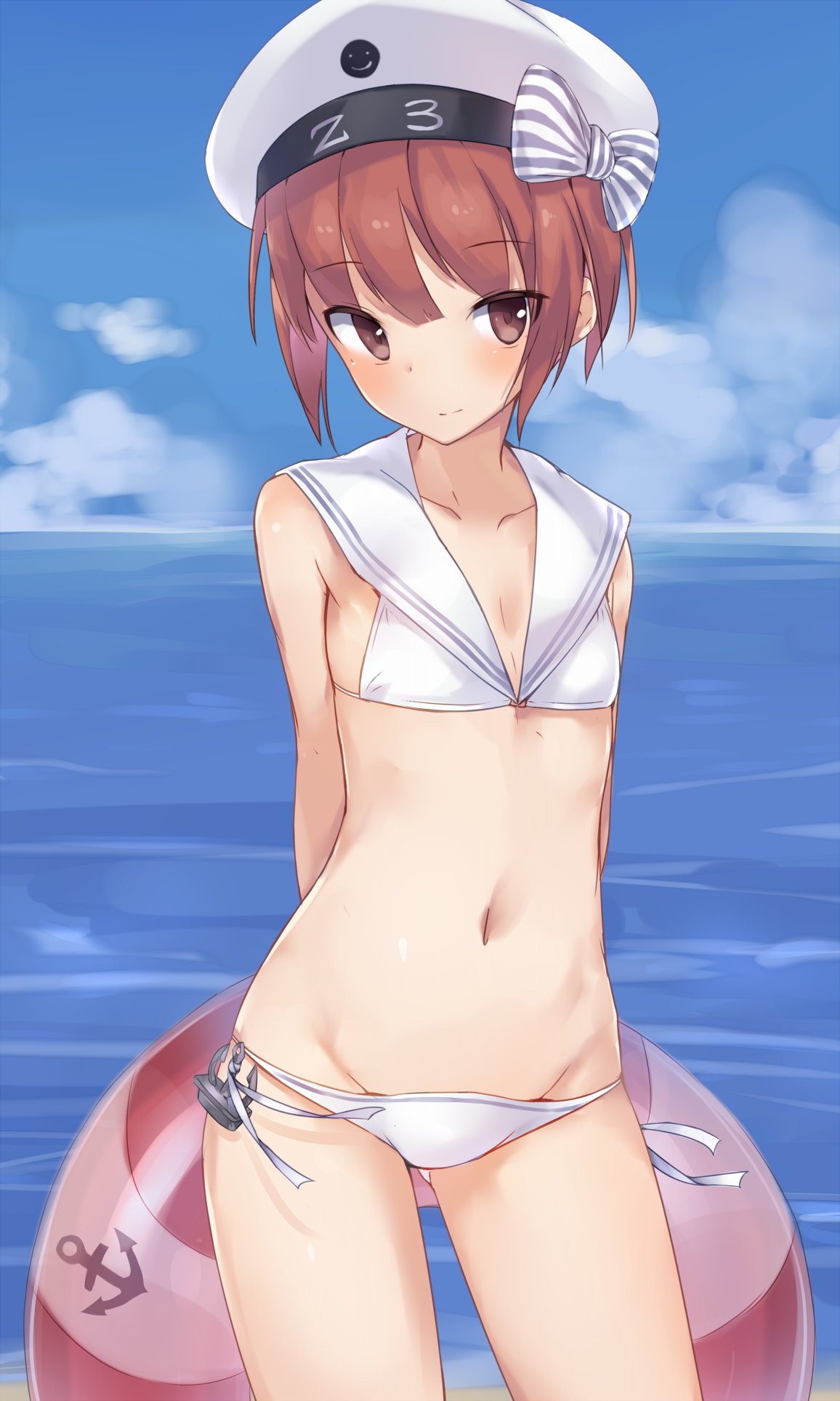 1girl anchor_symbol arms_behind_back auburn_hair bare_arms bare_shoulders beret bikini blue_sky blush bow brown_eyes character_name clothes_writing collarbone contrapposto cowboy_shot day eyebrows eyebrows_visible_through_hair flat_chest hat hat_bow hat_ornament highres holding horizon innertube kantai_collection looking_at_viewer metindone ocean sailor_bikini short_hair side-tie_bikini sky smile smiley_face solo standing striped striped_bow swimsuit water white_hat z3_max_schultz_(kantai_collection)