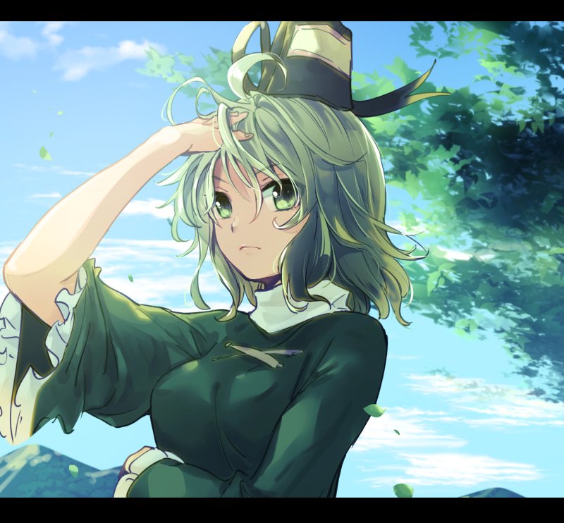 1girl ahoge arm_up bangs blue_sky breasts closed_mouth clouds day expressionless eyebrows_visible_through_hair frilled_sleeves frills green_eyes green_hair hair_between_eyes hat leaf letterboxed long_sleeves looking_at_viewer makuwauri medium_breasts mountain outdoors short_hair sky soga_no_tojiko solo tate_eboshi touhou