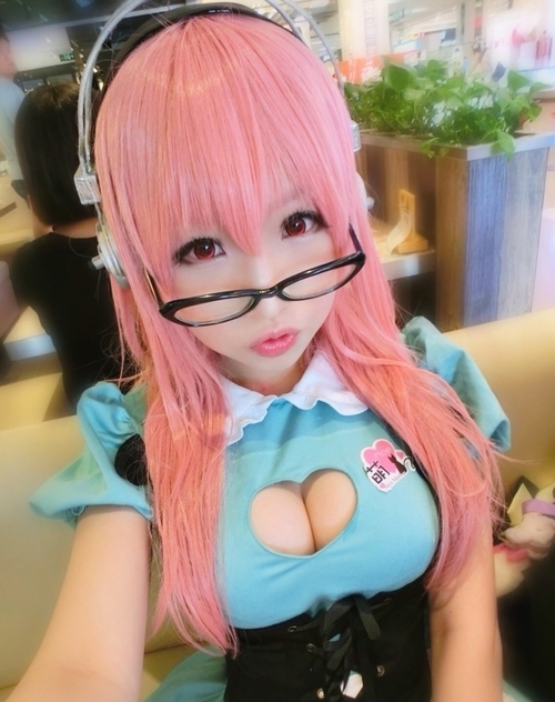1girl breasts cleavage cleavage_cutout cosplay glasses heart heart_cutout large_breasts nitroplus photo pink_hair self_shot super_sonico