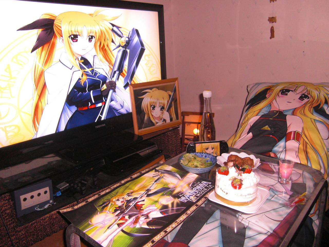 bardiche blonde_hair cake cup fate_testarossa food game_console gamecube lonely lyrical_nanoha mahou_shoujo_lyrical_nanoha mahou_shoujo_lyrical_nanoha_a's mahou_shoujo_lyrical_nanoha_strikers meal no_humans otaku_room photo playstation_3 product_placement television twintails
