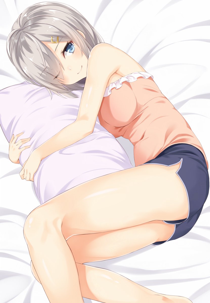 1girl bare_arms bare_shoulders bed bed_sheet blue_eyes blue_shorts eyes_visible_through_hair hair_ornament hair_over_one_eye hairclip hamakaze_(kantai_collection) highres kantai_collection light_smile looking_at_viewer lying note_(aoiro_clip) on_side one_eye_closed pillow pillow_hug pink_shirt shirt short_hair shorts tank_top thighs