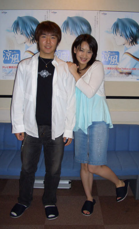 1boy 1girl bangs black_shirt black_shoes brown_hair chains denim denim_skirt hand_on_another's_shoulder hand_on_shoulder indoors jeans jewelry long_sleeves looking_at_viewer mitsuhashi_kanako necklace open_clothes open_shirt pants parted_lips photo real_life seiyuu shirt shoes skirt smile standing standing_on_one_leg suzuka white_shirt