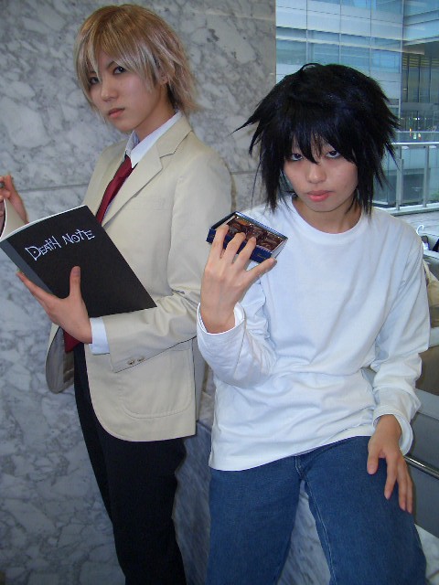 2boys asian bags_under_eyes cosplay death_note food l_(death_note) male_focus multiple_boys photo yagami_light