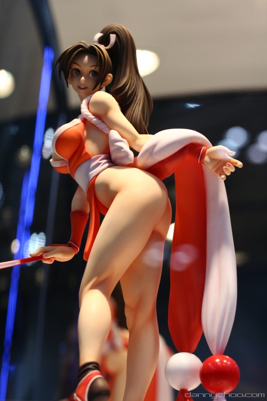 1girl ass breasts brown_eyes brown_hair closed_fan fan fatal_fury figure folding_fan king_of_fighters large_breasts long_hair no_panties pelvic_curtain photo ponytail revealing_clothes shiranui_mai snk solo the_king_of_fighters watermark wonder_festival wonder_festival_2007
