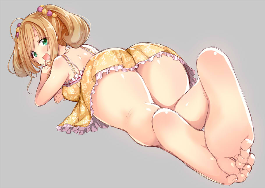 1girl ahoge ass bare_shoulders barefoot blonde_hair blush dress feet feet_together finger_to_mouth from_behind green_eyes idolmaster idolmaster_cinderella_girls jewelry looking_back lying on_stomach open_mouth pinky_out ring saki_chisuzu satou_shin simple_background smile soles solo toes twintails