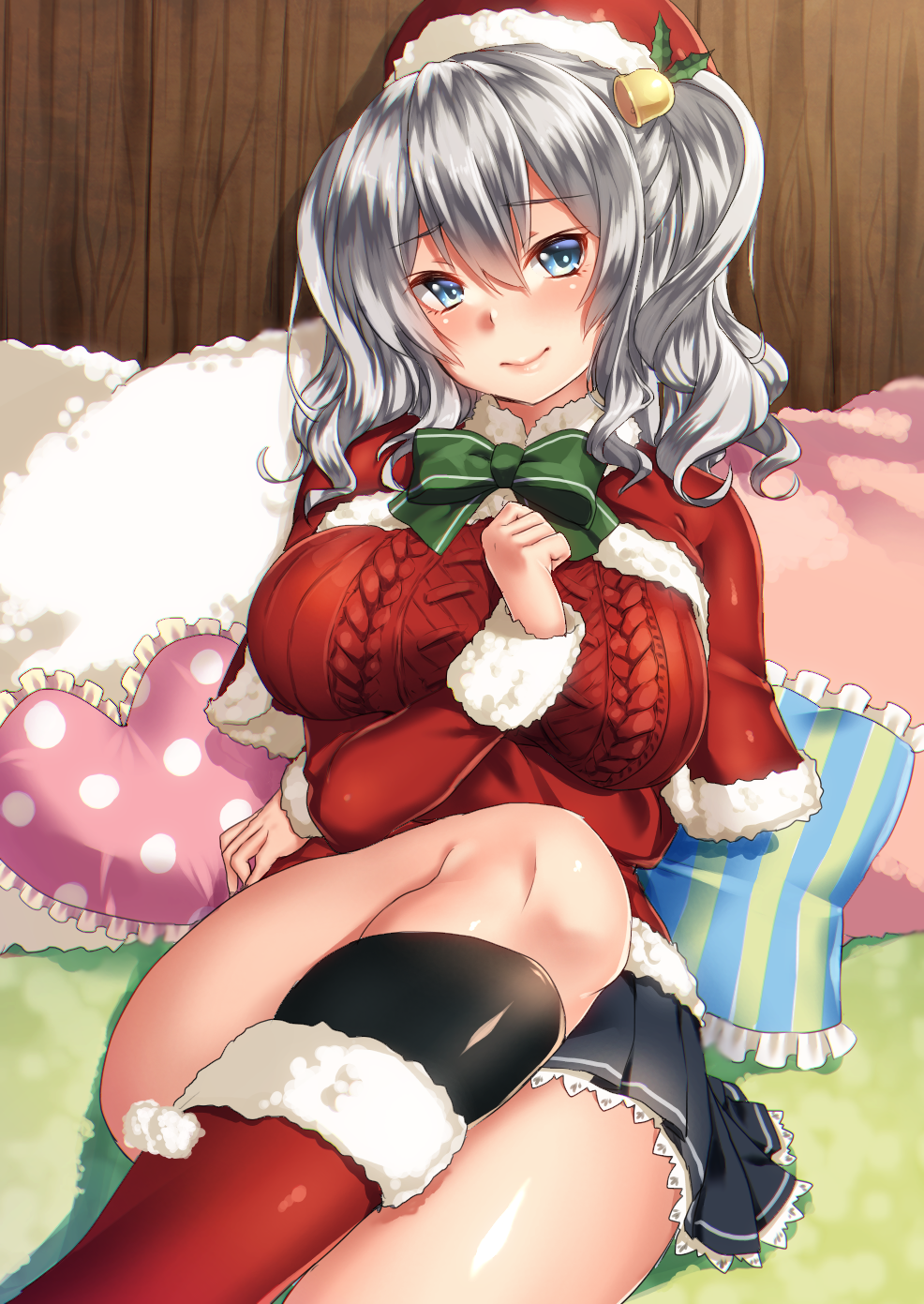 1girl alternate_costume aran_sweater black_legwear blue_eyes blue_skirt blush boots bow breasts christmas_ornaments eyebrows_visible_through_hair green_bow hair_between_eyes hair_ornament hat heart heart_pillow highres indoors jacket kantai_collection kashima_(kantai_collection) keita_(tundereyuina) large_breasts long_sleeves looking_at_viewer on_bed pillow pleated_skirt red_boots red_jacket santa_hat silver_hair skirt smile socks solo sweater twintails wooden_wall