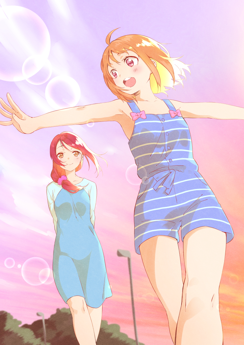 2girls :d ahoge arms_behind_back blush brown_eyes cowboy_shot dress foreshortening hair_ornament hair_scrunchie lamppost lens_flare long_hair love_live! love_live!_sunshine!! multiple_girls open_mouth orange_hair outdoors outstretched_arms redhead sakurauchi_riko scrunchie short_hair shorts smile spread_arms sunset takami_chika violet_eyes yomo_tsuka