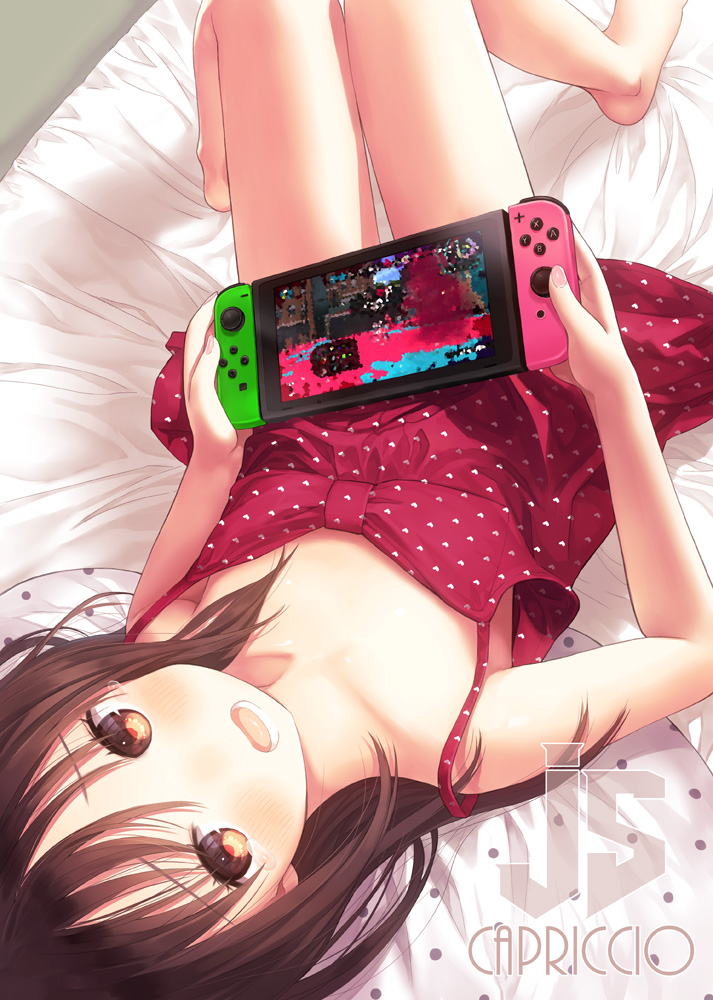 1girl artist_name bangs bed_sheet blush brown_eyes brown_hair capriccio collarbone dress eyebrows_visible_through_hair joy-con knees_up long_hair looking_at_viewer lying nintendo_switch on_back on_bed open_mouth original polka_dot polka_dot_dress polka_dot_pillow purple_dress smile solo teeth upside-down