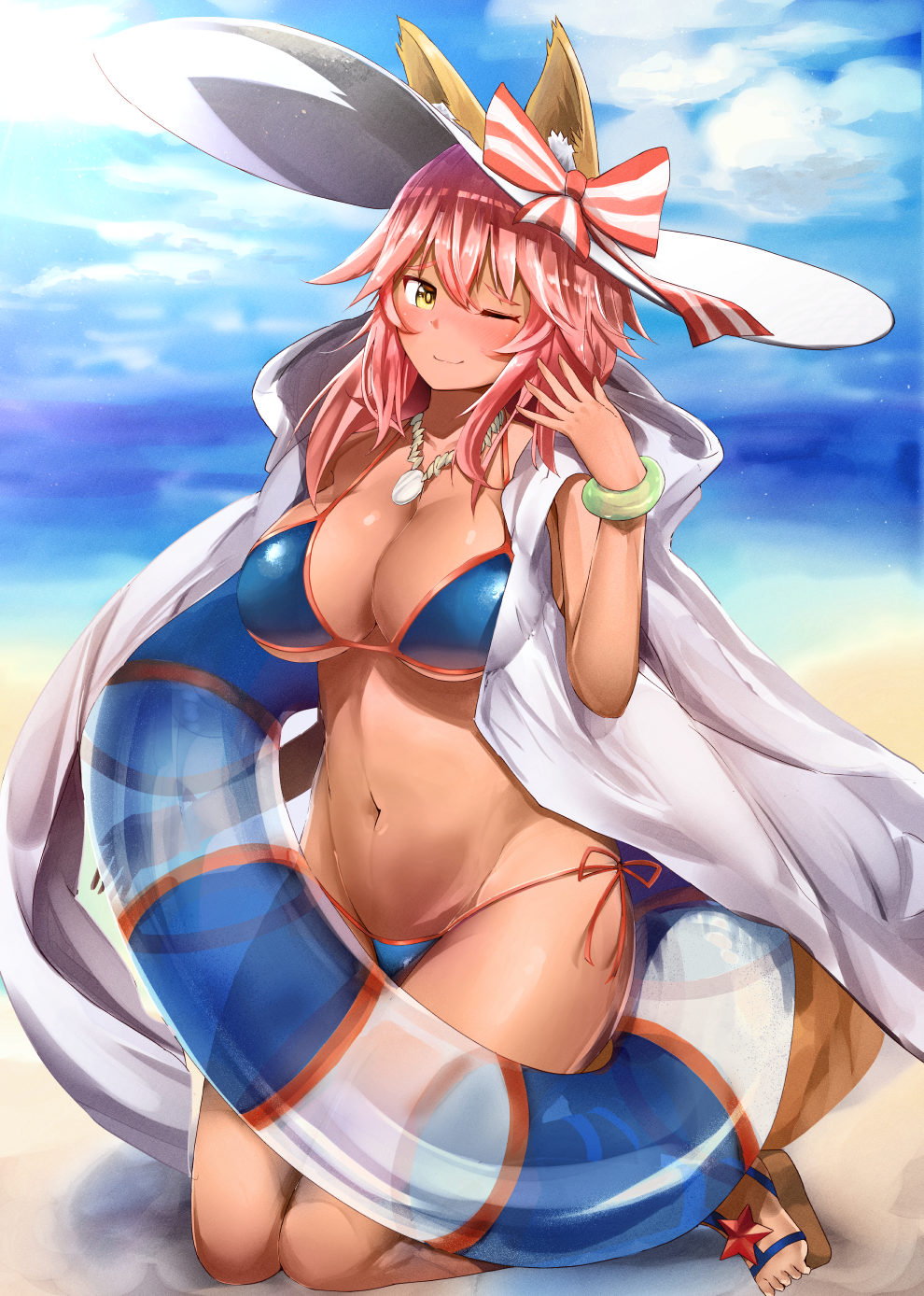 1girl animal_ears beach bikini blue_bikini blush breasts cleavage dark_skin day ears_through_headwear fate/extra fate/grand_order fate_(series) fox_ears fox_tail hat highres innertube large_breasts light_smile long_hair looking_at_viewer nanasumin navel ocean one_eye_closed outdoors pink_hair solo swimsuit tail tamamo_(fate)_(all) tamamo_no_mae_(swimsuit_lancer)_(fate) tan yellow_eyes