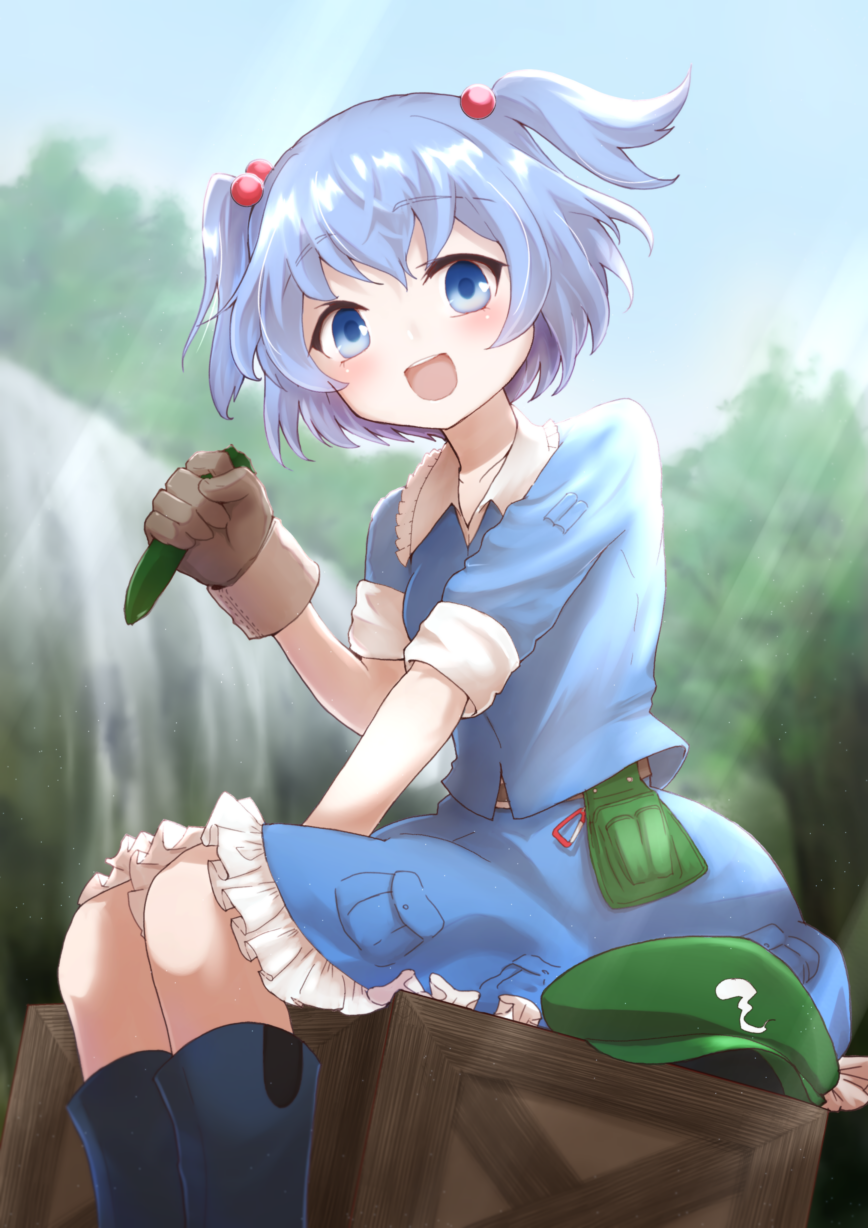 1girl blue_eyes blue_hair blue_skirt brown_gloves commentary_request crate cucumber day food forest gloves green_hat hair_bobbles hair_ornament hat hat_removed headwear_removed highres holding holding_food kawashiro_nitori kotarou_(yukina1721) looking_at_viewer nature open_mouth petticoat short_sleeves sitting skirt sky smile solo touhou two_side_up water waterfall