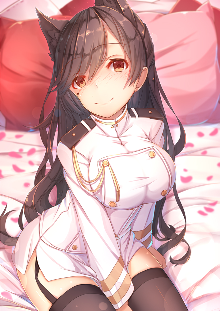 1girl animal_ears atago_(azur_lane) azur_lane between_legs black_legwear blurry blush breasts brown_eyes brown_hair closed_mouth commentary_request depth_of_field eyebrows_visible_through_hair garter_straps hand_between_legs head_tilt indoors large_breasts long_hair looking_at_viewer military military_uniform mole mole_under_eye on_bed petals pillow pink_pillow red_pillow sitting sitting_on_bed smile solo tatapopo thigh-highs uniform very_long_hair