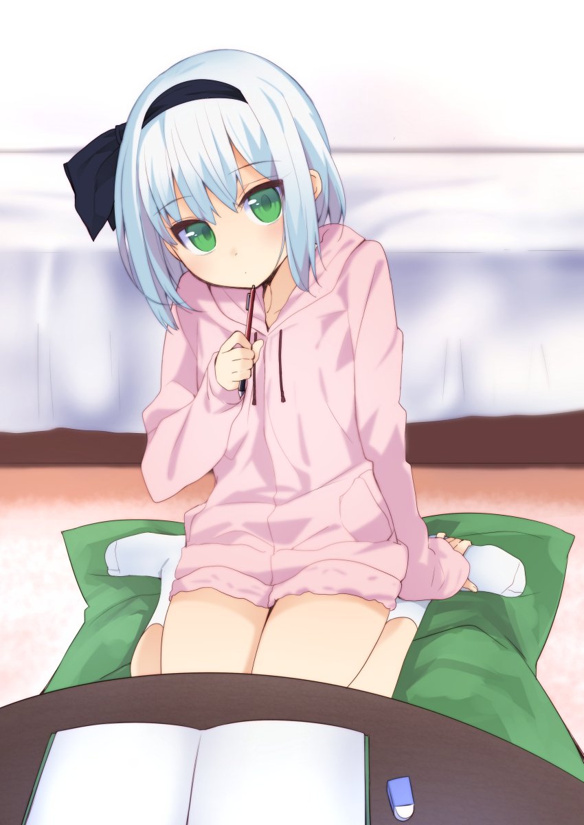 1girl alternate_costume bangs bare_legs bed black_hairband black_ribbon book drawstring eraser eyebrows_visible_through_hair green_eyes hairband hand_up highres hood hoodie indoors konpaku_youmu long_sleeves looking_at_viewer nigo_(aozoragarou) pencil ribbon sitting socks solo touhou wariza white_hair white_legwear