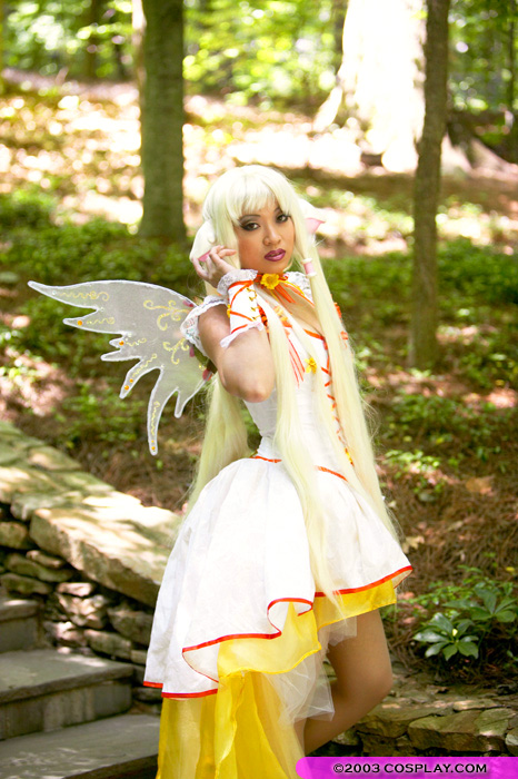 angelicstar blonde_hair bow chii chobits clamp cosplay long_dress long_hair photo photo_shoot photograph pigtails posing red_lipstick wings yellow_dress