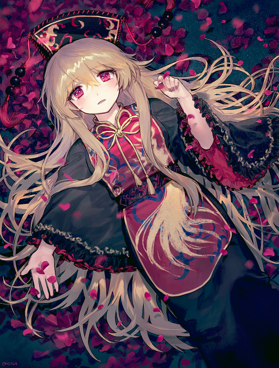 1girl ainy77 black_dress black_hat blonde_hair chinese_clothes crescent dress fingernails frilled_sleeves frills from_above hair_between_eyes hat junko_(touhou) long_hair long_sleeves looking_at_viewer lying on_back parted_lips petals red_eyes ribbon rose_petals sash shiny shiny_hair solo tabard tareme tassel touhou wide_sleeves yellow_ribbon