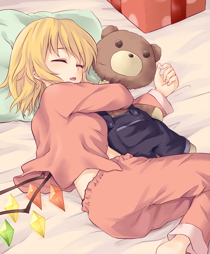1girl ass barefoot blonde_hair box breasts closed_eyes commentary_request flandre_scarlet gift gift_box long_sleeves lying medium_breasts midriff miyo_(ranthath) no_hat no_headwear object_hug on_side open_mouth overalls pajamas pants pillow pocket red_pants short_hair sleeping solo stuffed_animal stuffed_toy teddy_bear touhou wings