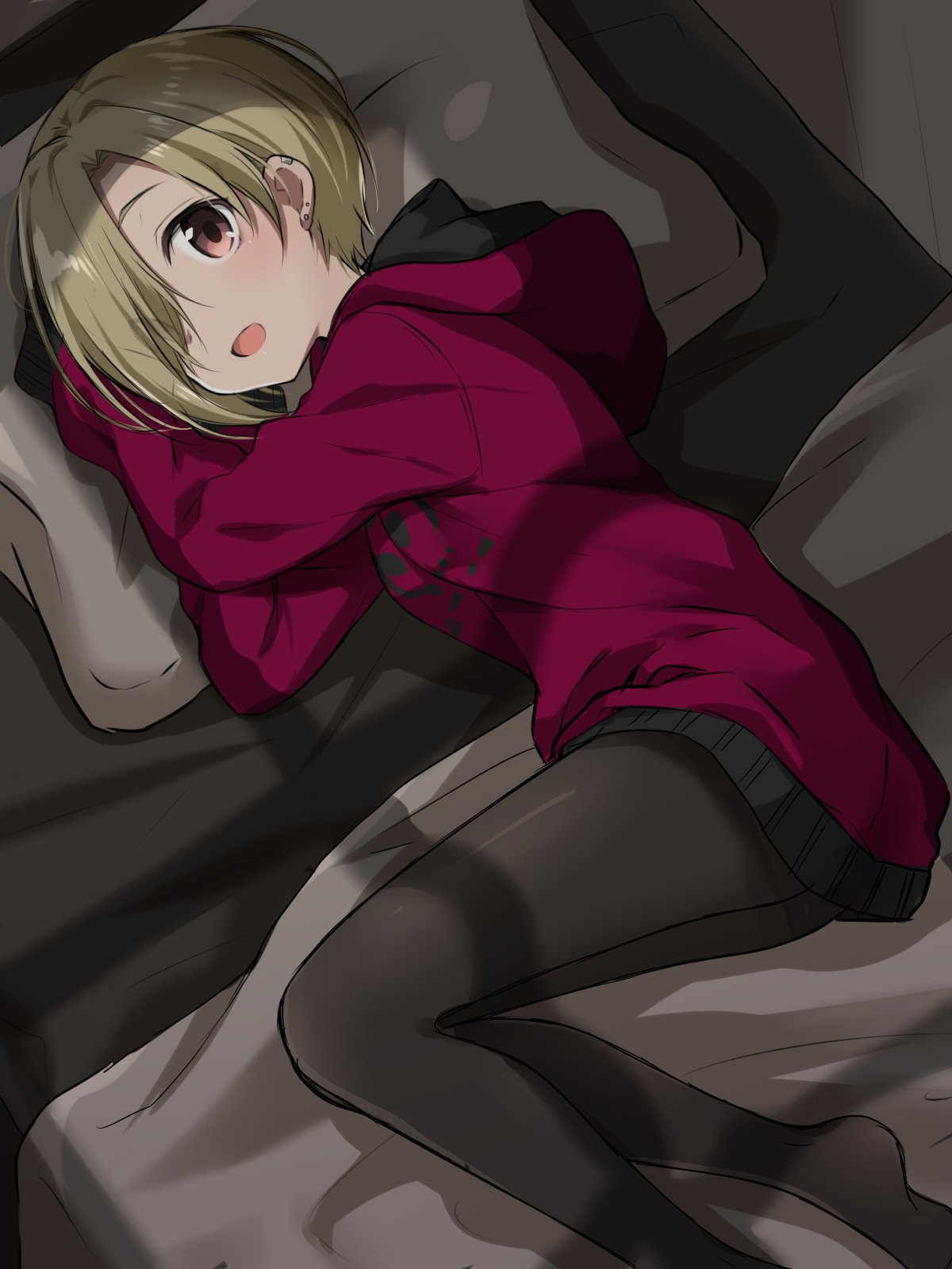 1girl bed bed_sheet blonde_hair brown_eyes commentary ear_piercing earrings hair_over_one_eye highres hood hood_down hoodie idolmaster idolmaster_cinderella_girls jewelry looking_at_viewer lying no_shoes nomu_ra_nomu on_side open_mouth pantyhose piercing pillow shade shadow shirasaka_koume short_hair sleeves_past_fingers sleeves_past_wrists smile solo window_shade