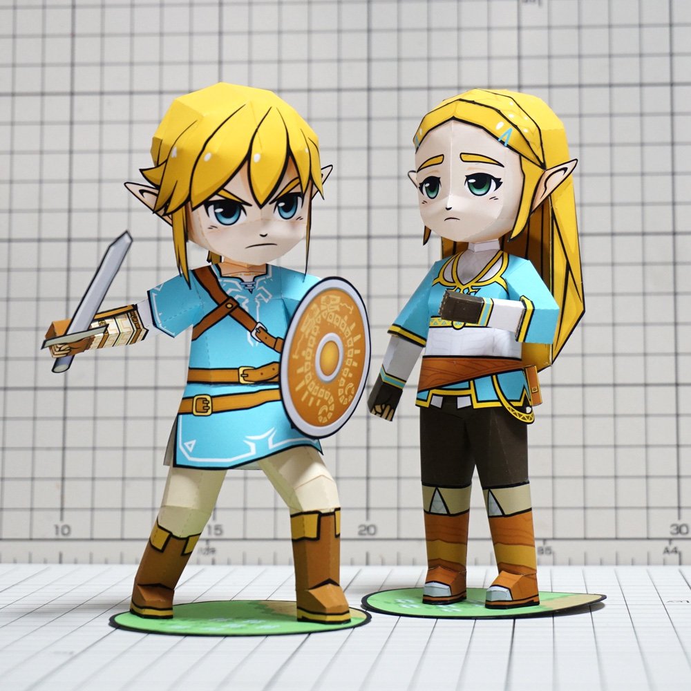 1boy 1girl aqua_eyes blonde_hair blue_eyes blue_shirt boots chibi full_body hair_ornament hairclip holding holding_sword holding_weapon link long_hair muumin_(muumin_craft) nintendo paper papercraft photo pointy_ears princess_zelda shield shirt short_hair sidelocks standing sword the_legend_of_zelda the_legend_of_zelda:_breath_of_the_wild weapon