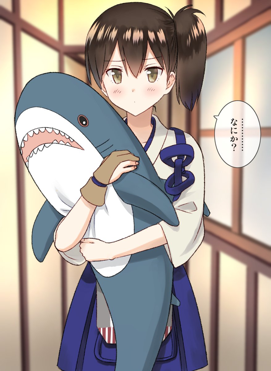 1girl blue_hakama blue_skirt brown_eyes brown_hair commentary cowboy_shot gloves hakama hakama_skirt hallway highres ikea_shark japanese_clothes kaga_(kantai_collection) kantai_collection kujira_naoto long_hair looking_at_viewer partly_fingerless_gloves shark side_ponytail skirt solo stuffed_animal stuffed_shark stuffed_toy tasuki translated yugake