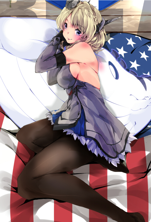 1girl american_flag bed black_gloves black_legwear blonde_hair blue_eyes blue_neckwear breasts colorado_(kantai_collection) commentary_request dress elbow_gloves garrison_cap gloves grey_dress hat headgear kagino kantai_collection large_breasts looking_at_viewer lying necktie on_side pantyhose pleated_dress short_hair side_braids sideboob sleeveless smile solo stuffed_toy stuffed_whale whale