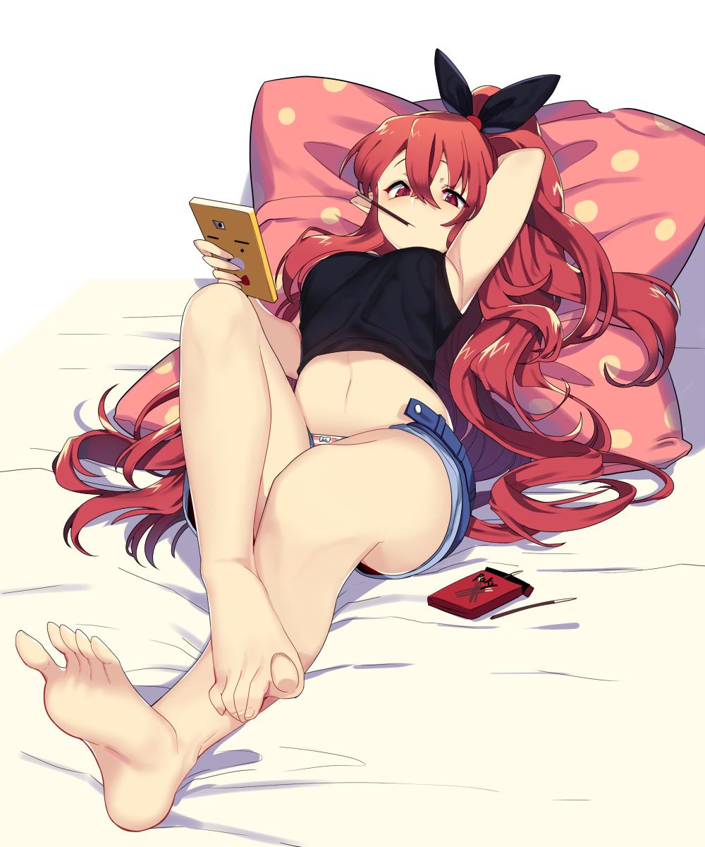1girl arm_behind_head bare_legs barefoot black_bow bow breasts cellphone character_request crop_top denim denim_shorts dungeon_and_fighter feet food food_in_mouth hair_between_eyes hair_bow highres holding holding_phone long_hair lying mendou_kusai navel open_fly panties pantyshot pantyshot_(lying) phone pillow pocky ponytail red_eyes redhead shorts sideboob solo striped striped_panties underwear
