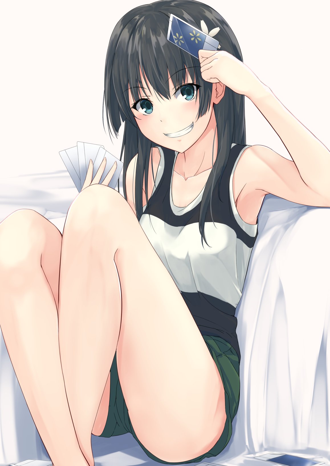 1girl bed black_hair card casual eyebrows_visible_through_hair feet_out_of_frame flower green_eyes green_shorts grin hair_flower hair_ornament highres k3rd long_hair looking_at_viewer saten_ruiko shorts simple_background sitting smile solo tank_top to_aru_kagaku_no_railgun to_aru_majutsu_no_index two-tone_shirt white_background