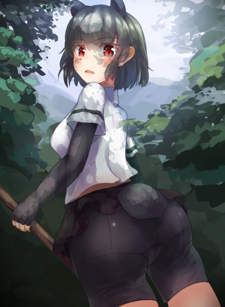 1girl animal_ears arms_at_sides ass bangs bear_ears bear_girl bear_tail bike_shorts black_hair brown_bear_(kemono_friends) commentary_request crotch_seam dappled_sunlight day dutch_angle elbow_gloves extra_ears eyebrows_visible_through_hair fingerless_gloves from_behind gloves holding holding_weapon kemono_friends looking_at_viewer looking_back medium_hair microskirt open_mouth oren_(770len) outdoors red_eyes shirt short_sleeves shorts shorts_under_skirt sidelocks skirt solo standing sunlight tail tail_through_clothes twisted_torso weapon