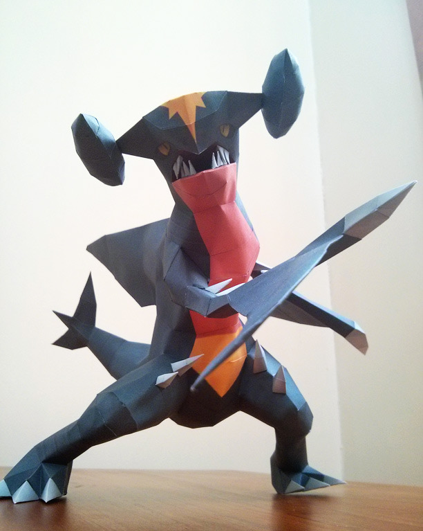 claws commentary creature dragon english_commentary full_body garchomp gen_4_pokemon legs_apart looking_at_viewer mcgmark no_humans papercraft photo pokemon pokemon_(creature) solo standing yellow_eyes