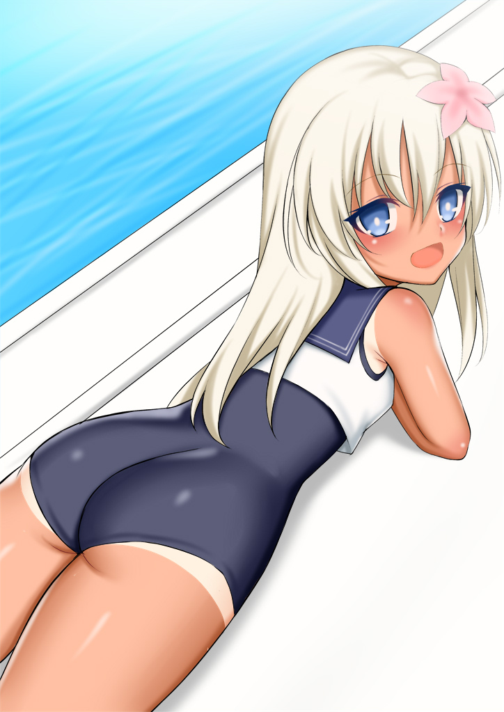 1girl ass blonde_hair blue_eyes blue_sailor_collar commentary_request crop_top flower from_behind hair_flower hair_ornament kantai_collection long_hair looking_at_viewer lying on_stomach one-piece_swimsuit pool poolside ro-500_(kantai_collection) sailor_collar school_swimsuit smile solo swimsuit tan tanline toshishikisai