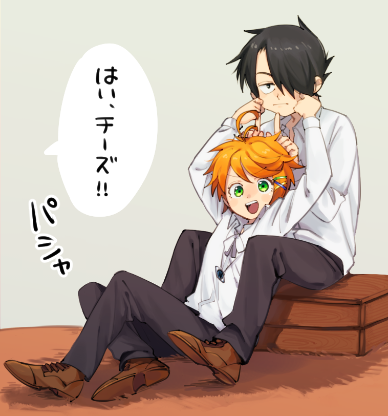 1boy 1girl ahoge arms_up black_eyes black_hair brown_footwear closed_mouth collar collared_shirt commentary_request daidaiika emma_(yakusoku_no_neverland) eyebrows_visible_through_hair finger_horns full_body green_eyes grey_background grey_pants hair_over_one_eye hands_on_another's_cheeks hands_on_another's_face holding long_sleeves looking_at_viewer neckwear open_mouth orange_hair pants ray_(yakusoku_no_neverland) shirt shoes short_hair simple_background sitting stretching_cheeks teeth translation_request white_shirt yakusoku_no_neverland