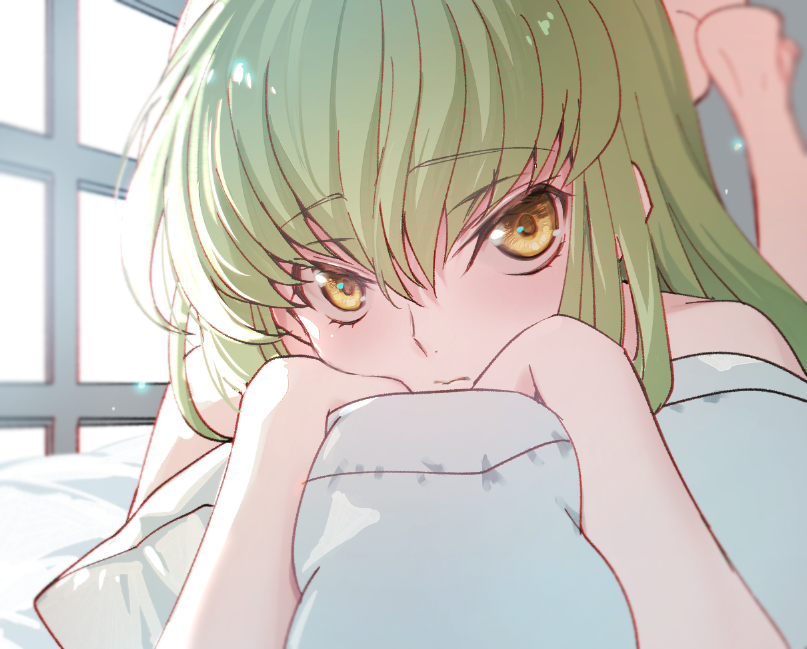 1girl blurry blurry_background c.c. closed_mouth code_geass creayus eyebrows_visible_through_hair green_hair hair_between_eyes leg_up long_hair looking_at_viewer lying on_stomach pillow pillow_hug sidelocks solo sunlight window yellow_eyes