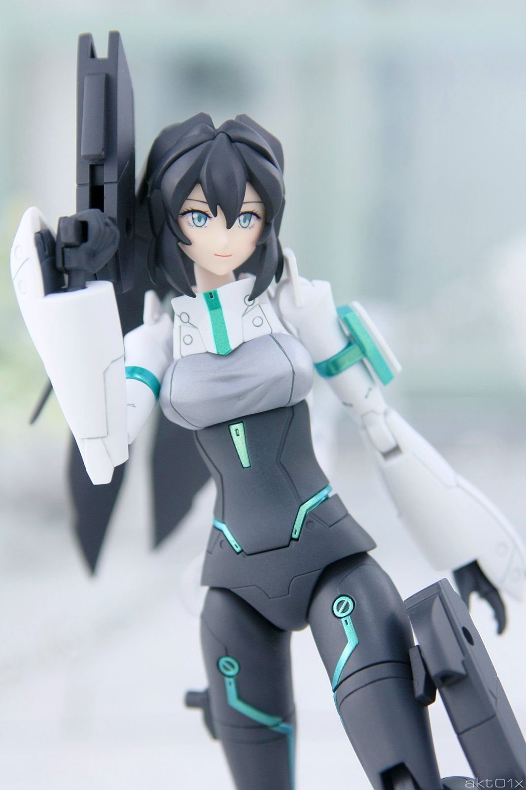 1girl akt01x black_hair dual_wielding grey_eyes gun gundam gundam_build_divers gundam_build_divers_re:rise gunpla highres holding holding_gun holding_weapon light_smile looking_to_the_side may_(gundam_build_divers_re:rise) model_kit photo weapon