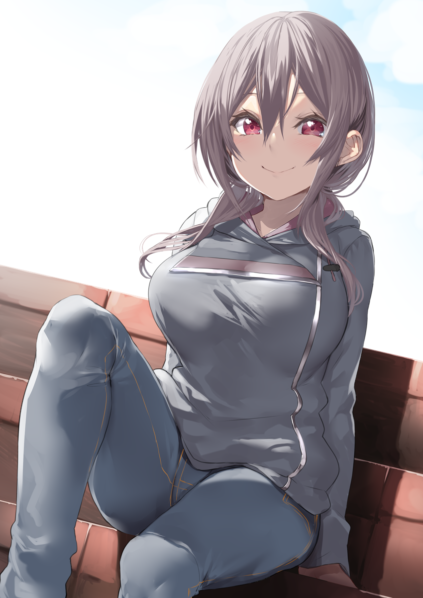 1girl blue_pants breasts brick_wall brown_hair denim grey_hoodie hair_between_eyes highres hood hood_down jeans large_breasts long_hair long_sleeves looking_at_viewer object_on_breast original pants red_eyes sidelocks smile solo yappen