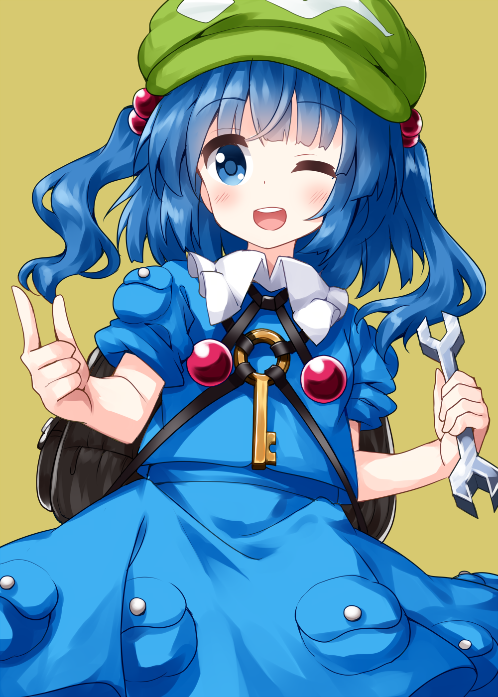 1girl backpack bag bangs black_bag blue_dress blue_eyes blue_hair blunt_bangs cowboy_shot dress eyebrows_visible_through_hair flat_cap green_headwear hair_bobbles hair_ornament hat highres holding holding_wrench kawashiro_nitori key looking_at_viewer medium_hair one_eye_closed open_mouth pocket pointing ruu_(tksymkw) simple_background smile solo standing teeth touhou two_side_up wrench yellow_background