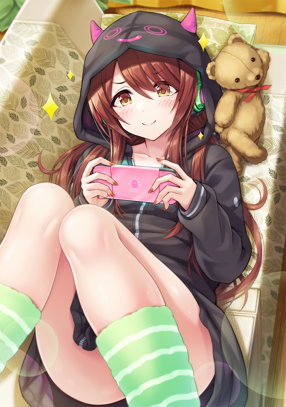1girl ass bangs black_jacket blush brown_eyes brown_hair closed_mouth commentary_request couch eyebrows_visible_through_hair fake_horns feet_out_of_frame green_legwear hair_over_one_eye handheld_game_console headphones highres holding hood hood_up hooded_jacket horned_hood horns idolmaster idolmaster_shiny_colors indoors jacket knees_up long_hair long_sleeves looking_at_viewer lying nail_polish on_back on_couch oosaki_tenka pillow red_nails sleeves_past_wrists smile socks solo sparkle striped striped_legwear stuffed_animal stuffed_toy teddy_bear urabi_(tomatohouse) very_long_hair