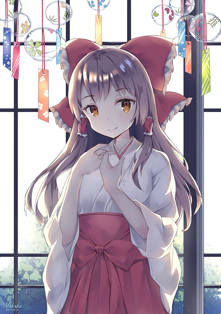 1girl artist_name bangs bow breasts brown_eyes brown_hair closed_mouth day eyebrows_visible_through_hair hair_bow hair_ornament hair_tubes hakurei_reimu hands_up indoors japanese_clothes long_hair looking_at_viewer mikako sidelocks smile solo touhou wind_chime