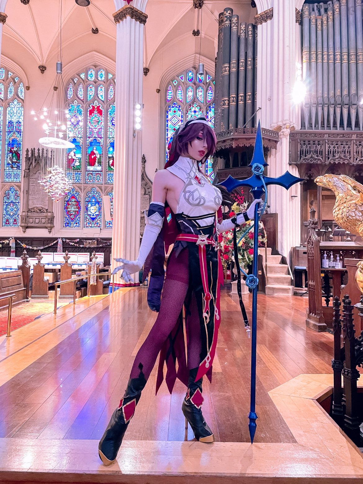 1girl anaeliccosplay bare_shoulders black_footwear boots christianity church commentary cosplay_photo elbow_gloves english_commentary full_body genshin_impact gloves hair_over_one_eye high_heel_boots high_heels highres holding holding_polearm holding_weapon indoors looking_at_viewer pantyhose photo_(medium) polearm purple_hair purple_legwear rosaria_(genshin_impact) solo spear stained_glass weapon