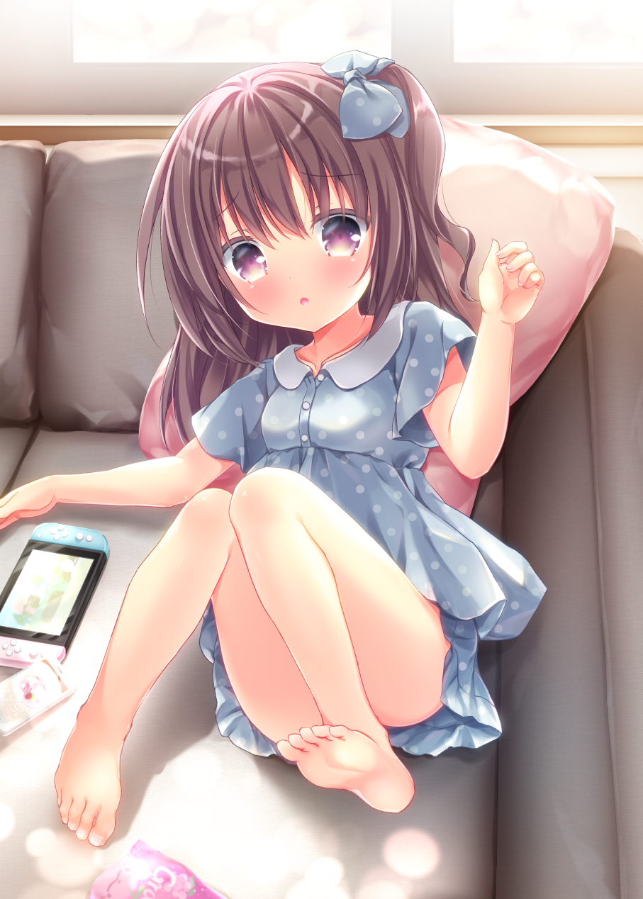 1girl arm_up barefoot blue_dress blush bow brown_hair child convenient_censoring convenient_leg couch dress feet hair_bow highres knees_together_feet_apart knees_up legs long_hair looking_at_viewer loungewear lying nintendo_switch on_back open_mouth original pillow pink_eyes polka_dot polka_dot_dress refia_(lollipop_star) ribbon short_dress short_sleeves side_ponytail soles solo thighs toes