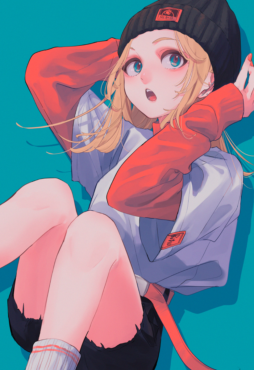 1girl aqua_background aqua_eyes arms_up beanie black_headwear black_shorts blonde_hair blush feet_out_of_frame hat highres knees_up layered_sleeves long_hair long_sleeves open_mouth original red_nails ritao_kamo shadow shirt short_over_long_sleeves short_sleeves shorts simple_background solo white_shirt