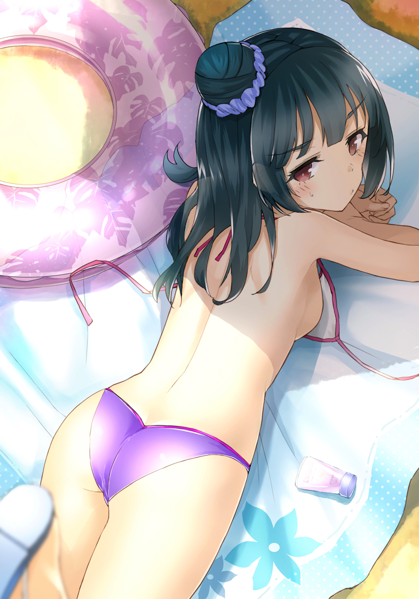 1girl ass bangs bikini black_hair blurry blurry_foreground blush breasts brown_eyes closed_mouth commentary_request day depth_of_field eyebrows_visible_through_hair from_above hair_bun hair_ornament hair_scrunchie highres innertube looking_at_viewer looking_back looking_up love_live! love_live!_sunshine!! lying on_stomach outdoors purple_bikini purple_scrunchie sakasa_(guranyto) sand scrunchie side_bun small_breasts solo sweat swimsuit topless tsushima_yoshiko