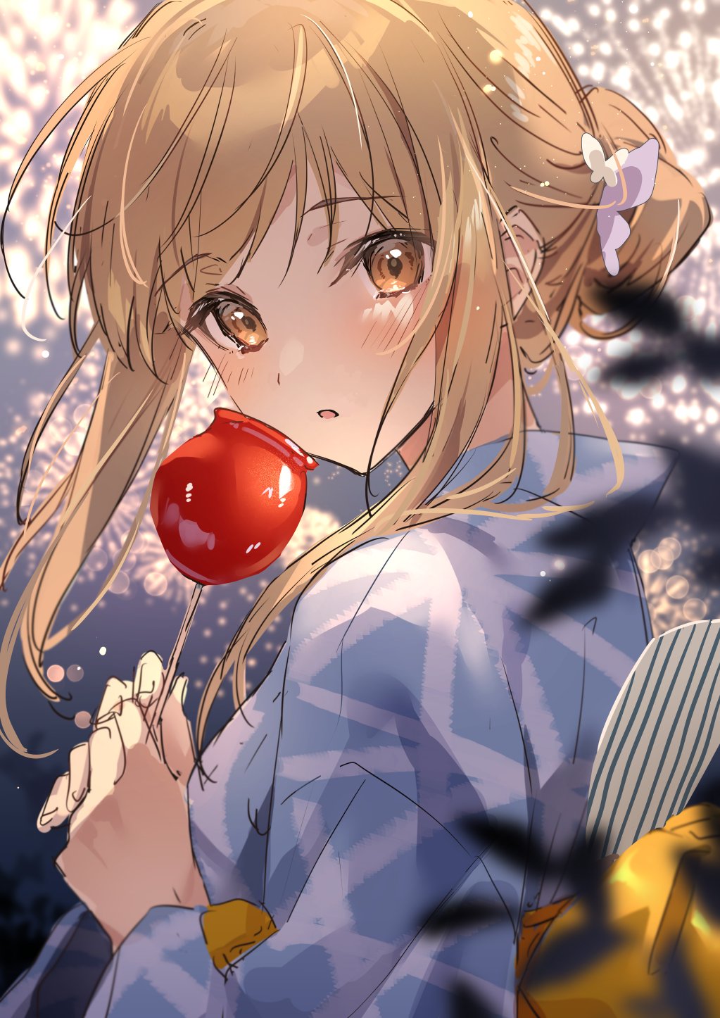 1girl :o bangs blonde_hair blue_kimono blurry blurry_background blush brown_eyes candy_apple fireworks food hair_bun highres holding holding_food japanese_clothes kimono long_hair long_sleeves looking_at_viewer looking_back obi original parted_lips sash solo zattape