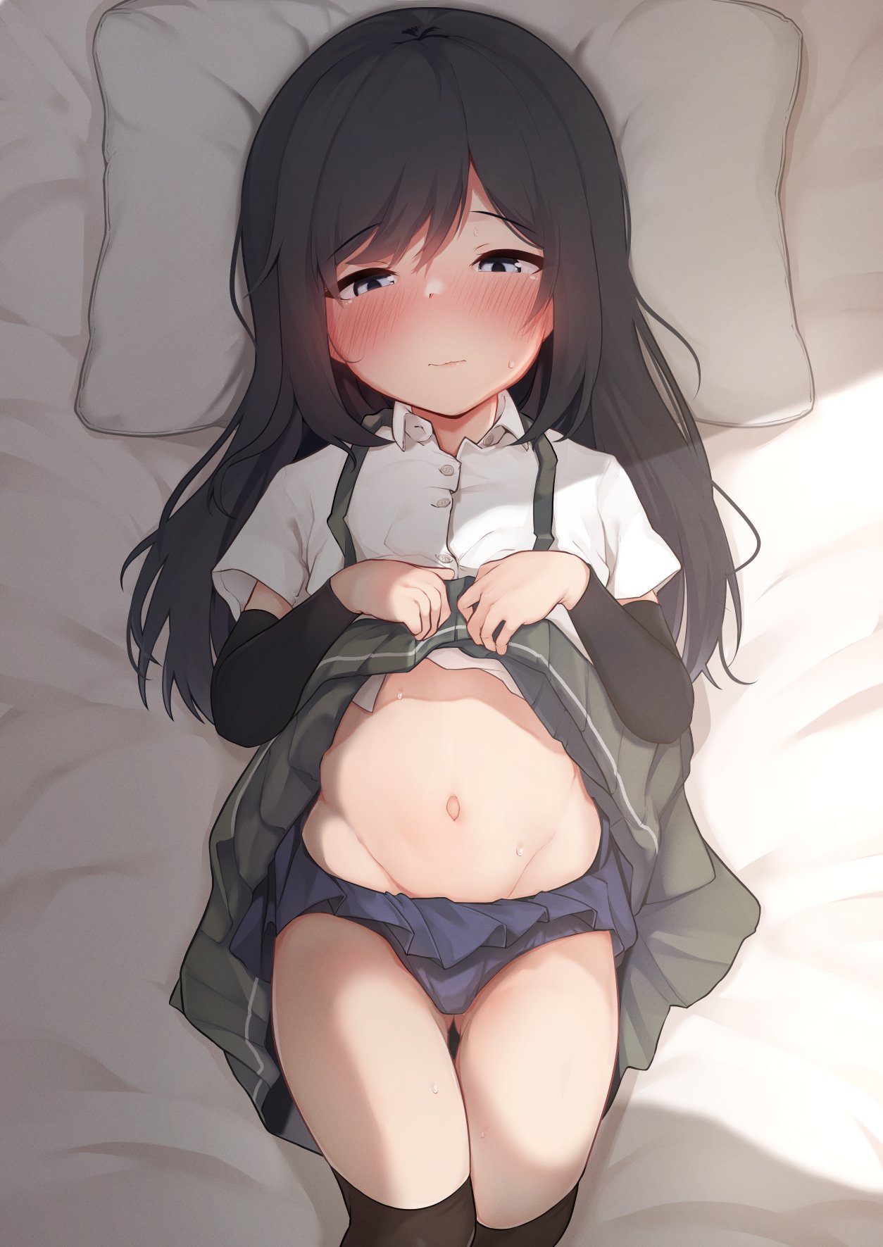 1girl arm_warmers asashio_(kancolle) bangs bed bikini bikini_under_clothes black_hair black_legwear blue_bikini blue_eyes blush closed_mouth clothes_lift eyebrows_visible_through_hair grey_skirt highres kantai_collection kneehighs lifted_by_self long_hair lying nagatsukiin navel on_back on_bed shirt short_sleeves skirt skirt_lift solo suspender_skirt suspenders sweat swimsuit wavy_mouth white_shirt