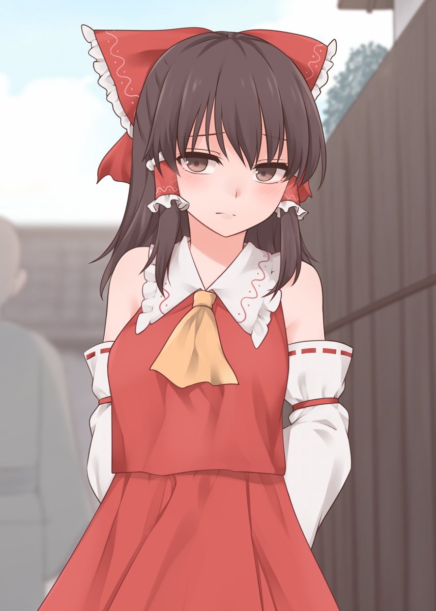 1girl arms_behind_back ascot bangs bare_shoulders black_hair blurry blurry_background bow brown_eyes commentary_request day detached_sleeves frilled_bow frilled_shirt_collar frills hair_bow hair_tubes hakurei_reimu highres large_bow long_hair looking_at_viewer miyo_(ranthath) outdoors red_skirt red_vest skirt solo touhou vest yellow_neckwear