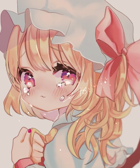 1girl :s ascot bangs blonde_hair blush bow crying crying_with_eyes_open eyebrows_visible_through_hair face fang flandre_scarlet from_side grey_background hair_bow hat looking_at_viewer mob_cap moni_monico one_side_up red_bow red_nails short_hair signature simple_background skin_fang solo tearing_up tears touhou upper_body wrist_cuffs yellow_neckwear