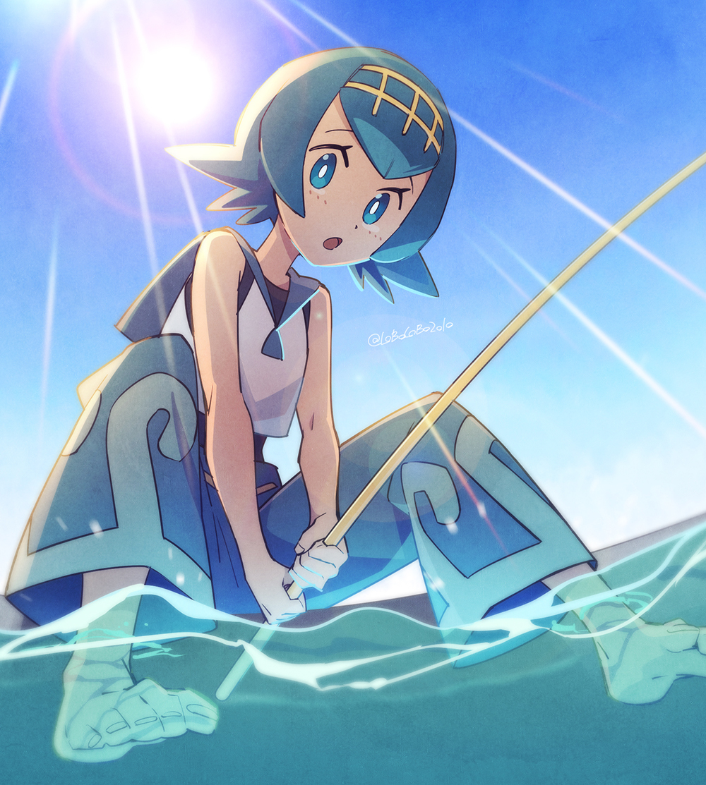 1girl bangs bare_arms barefoot black_swimsuit blue_eyes blue_hair blue_pants blue_sailor_collar bright_pupils commentary day eyelashes fishing_rod freckles from_below hairband holding holding_fishing_rod lana_(pokemon) lens_flare looking_at_viewer momoji_(lobolobo2010) no_sclera one-piece_swimsuit open_mouth outdoors pants pokemon pokemon_(game) pokemon_sm sailor_collar shirt short_hair sky sleeveless sleeveless_shirt soaking_feet solo sun swimsuit swimsuit_under_clothes toes tongue twitter_username water white_pupils white_shirt yellow_hairband