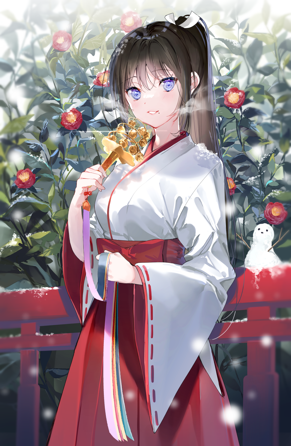 1girl bangs bell black_hair blue_eyes blush bush cowboy_shot eyebrows_visible_through_hair flower hakama highres hip_vent holding japanese_clothes jingle_bell kimono long_hair long_sleeves looking_at_viewer miko miwano_ragu mole mole_under_mouth motion_blur official_art original parted_lips ponytail railing red_flower red_hakama smile snow snow_sculpture snowing solo white_kimono wide_sleeves