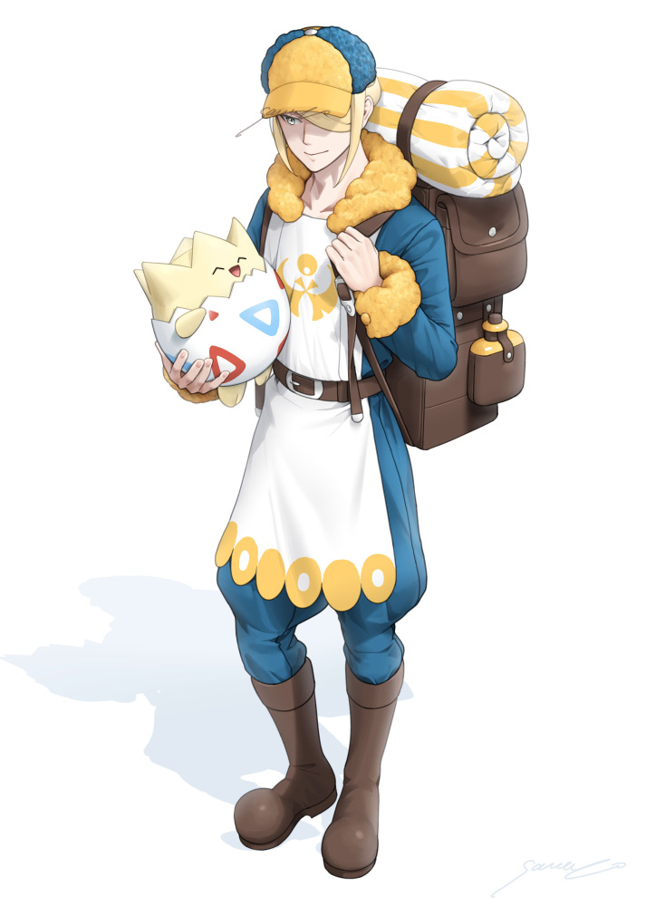 1boy backpack bag belt blonde_hair blue_jumpsuit boots brown_bag brown_belt brown_footwear closed_mouth commentary_request grey_eyes hair_over_one_eye hat holding holding_pokemon holding_strap jumpsuit male_focus pokemon pokemon_(creature) pokemon_(game) pokemon_legends:_arceus sawaco_(sawaco520) short_hair signature smile standing togepi volo_(pokemon) yellow_headwear