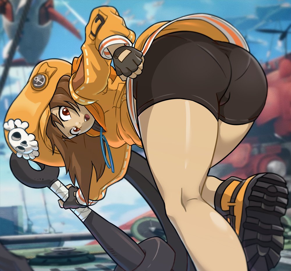 1girl anchor ass bent_over bike_shorts blurry blurry_background brown_hair centinel303 fingerless_gloves gloves guilty_gear guilty_gear_strive hat holding holding_anchor hood hoodie long_hair looking_at_viewer may_(guilty_gear) open_mouth orange_headwear orange_hoodie pantylines pirate_hat skull_and_crossbones solo